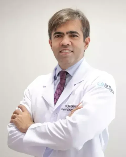 Retrato do Dr. Jon Marks de jaleco, com os braços cruzados